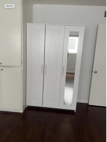 an empty room with wooden floor