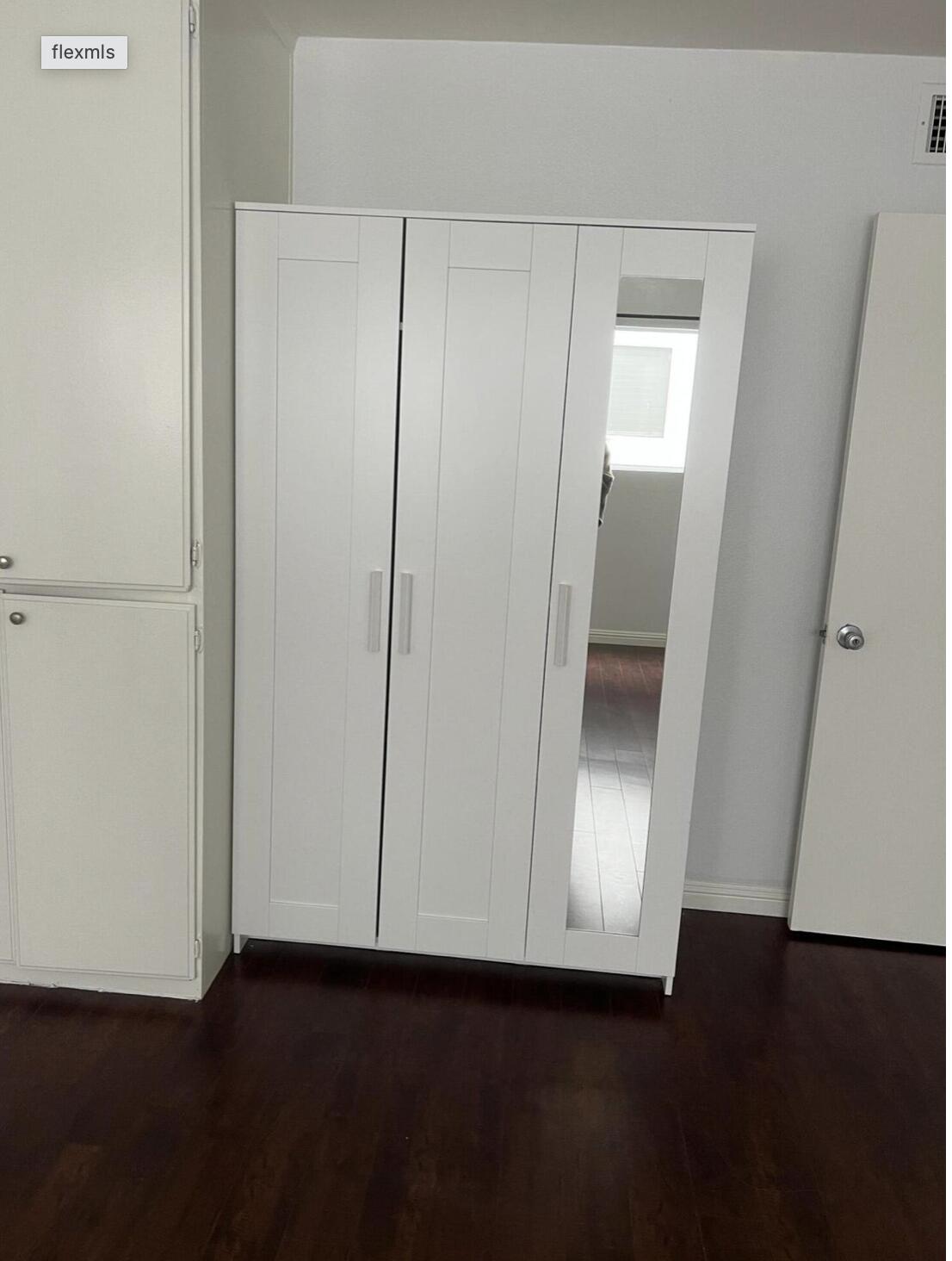 18555 Collins Street, Unit C8 Tarzana, CA 91356 - Photo 28 of 32 a view of an empty room with wooden floor and a window