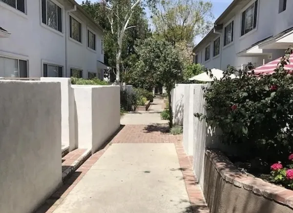 a view of a house with backyard and sitting area