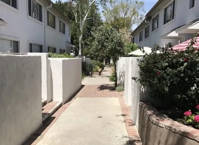 a view of a house with backyard and sitting area