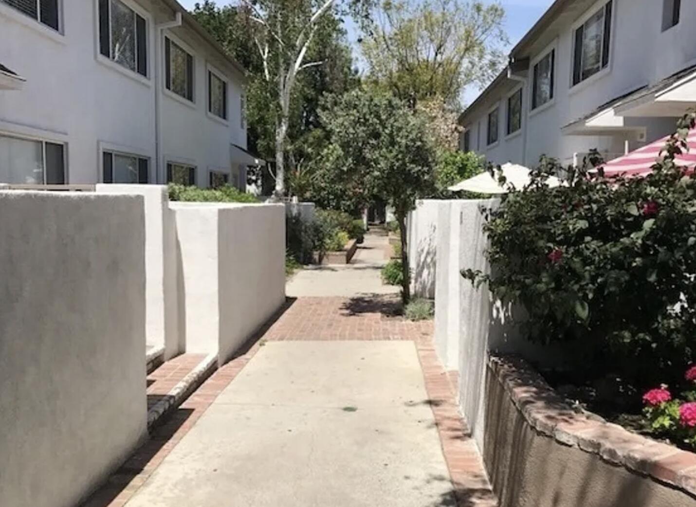 18555 Collins Street, Unit C8 Tarzana, CA 91356 - Photo 3 of 32 a view of a house with backyard and sitting area