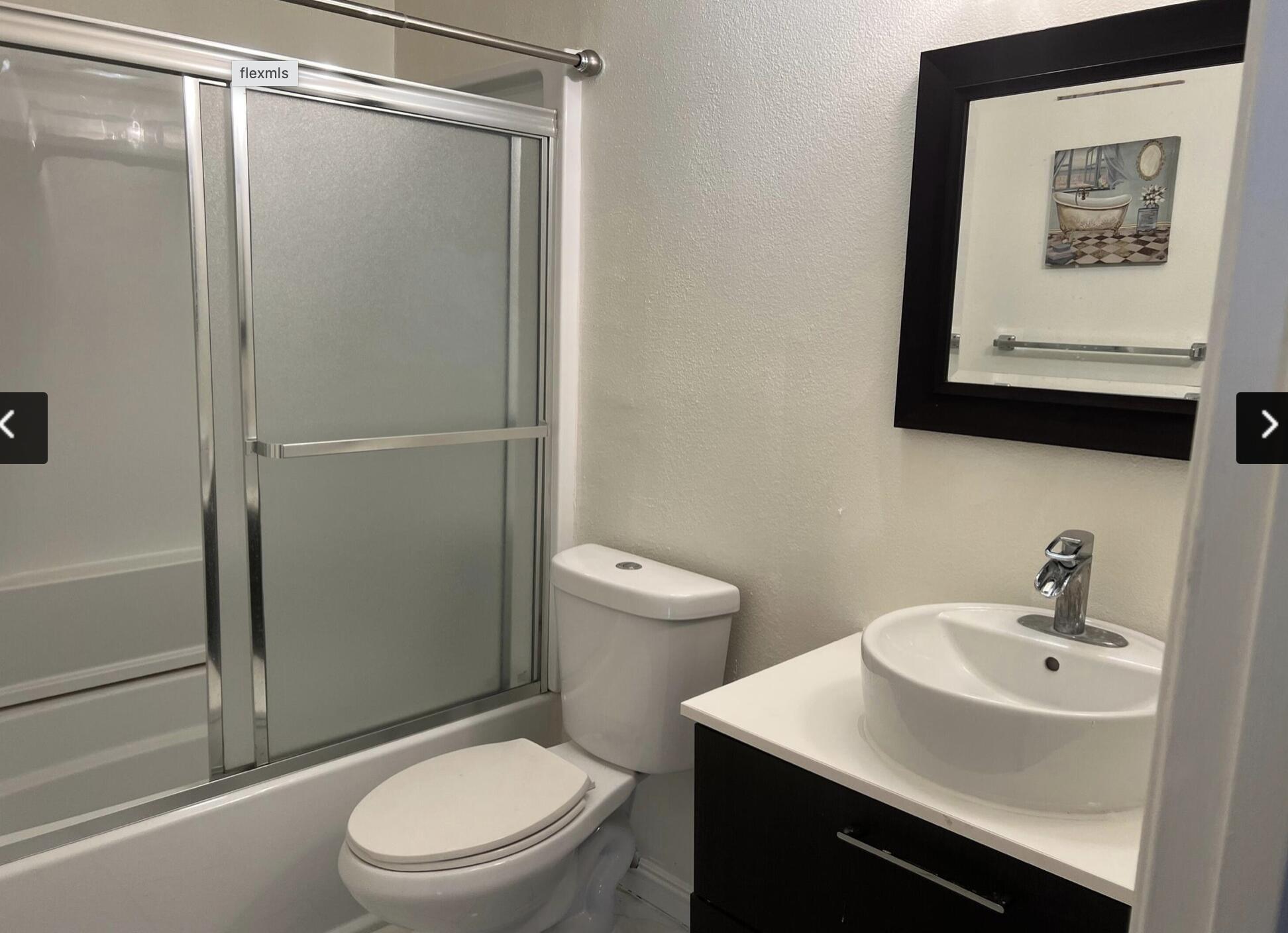 18555 Collins Street, Unit C8 Tarzana, CA 91356 - Photo 32 of 32 a bathroom with a toilet a sink and shower