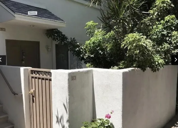 a view of a house with a flower garden