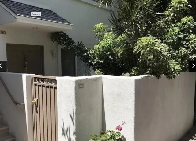 a view of a house with a flower garden