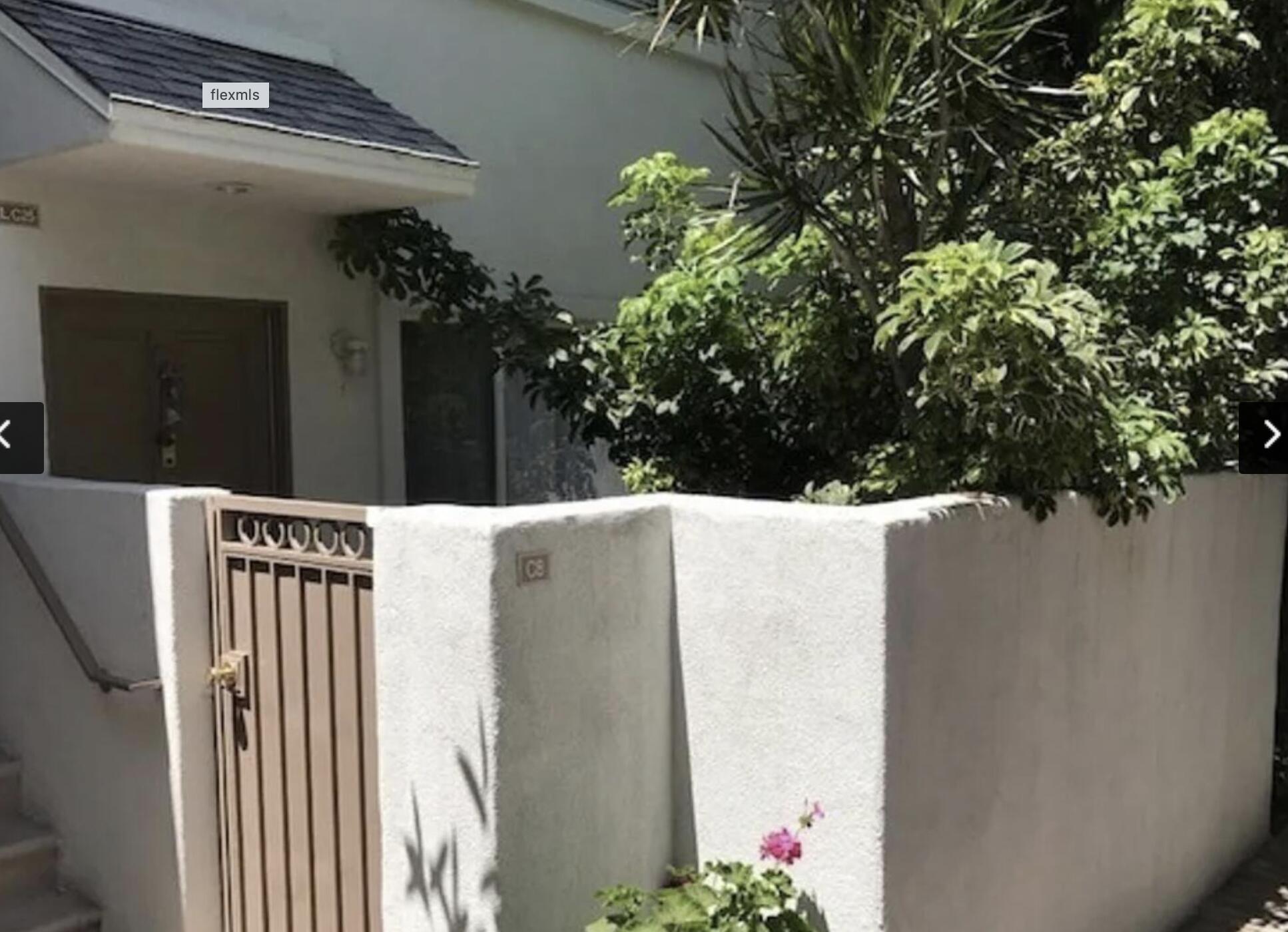 18555 Collins Street, Unit C8 Tarzana, CA 91356 - Photo 6 of 32 a view of a house with a flower garden