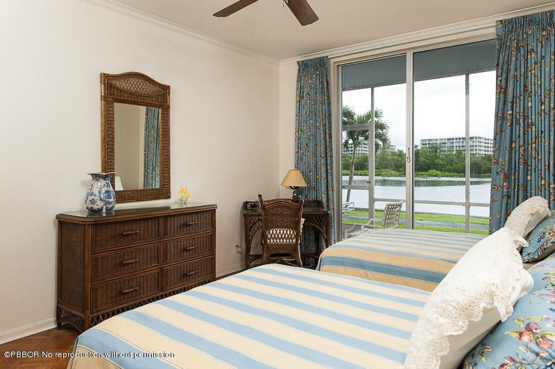 2165 Ibis Isle Road, Unit 2 Palm Beach, FL 33480 - Photo 4 of 7 a bedroom with a bed and wooden floor