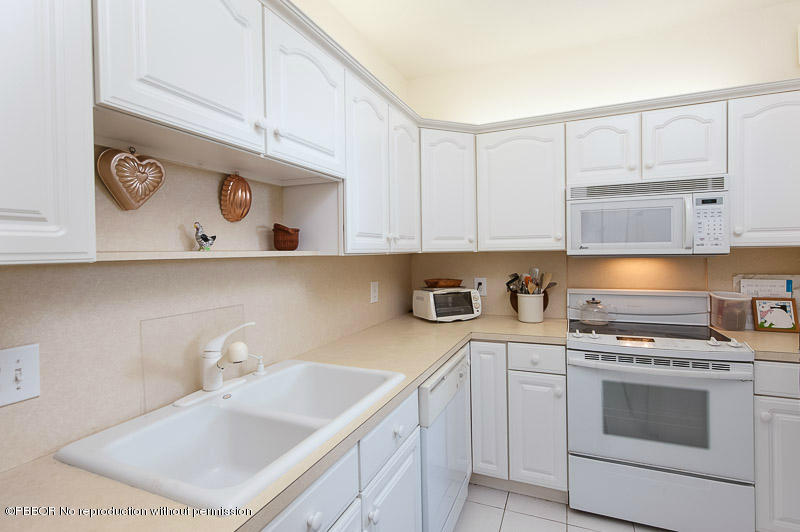 2165 Ibis Isle Road, Unit 2 Palm Beach, FL 33480 - Photo 5 of 7 a kitchen with stainless steel appliances granite countertop a sink a stove and cabinets