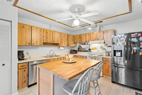 a kitchen with a sink a stove and cabinets