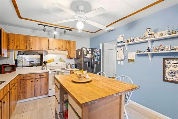 a kitchen with a window dining table and chairs