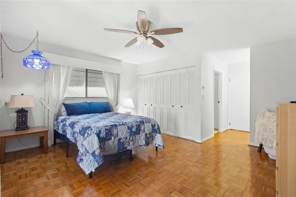 a bedroom with a bed and a large window with outer view
