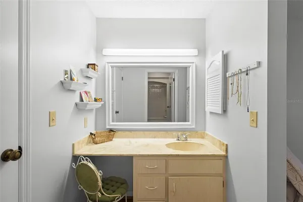 a bedroom that has a bed and a chair in it