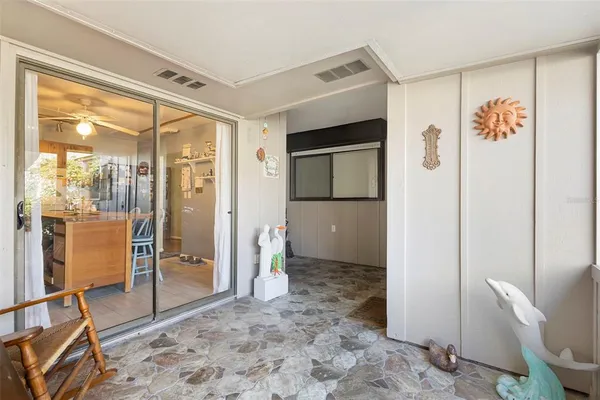 a view of kitchen with furniture and refrigerator
