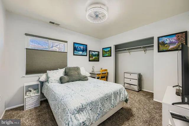 a bedroom with a bed and cabinets