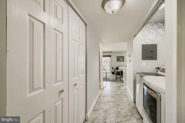 a view of a kitchen with a sink washer and dryer