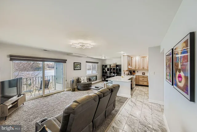 a living room with furniture large window and flat screen tv