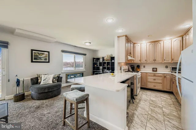a kitchen that has a sink and chairs