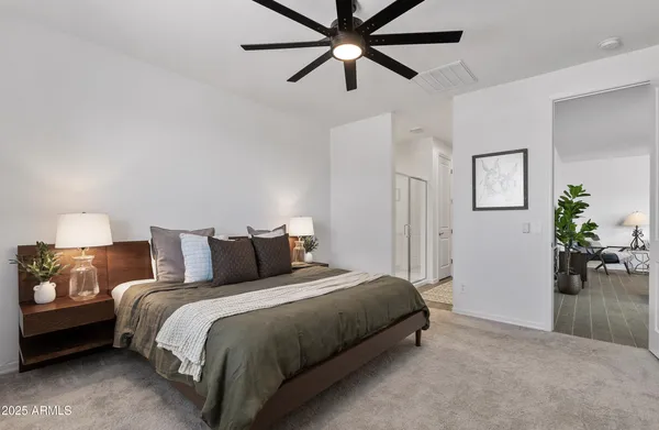 a bedroom with a bed and ceiling fan
