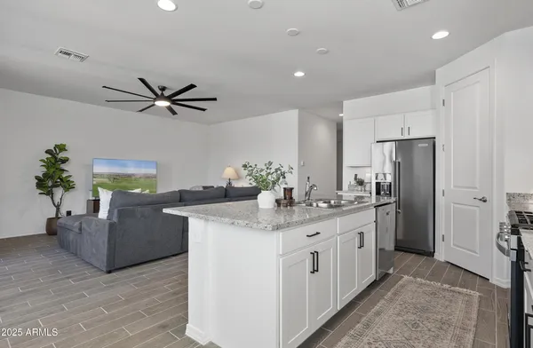 a kitchen with a refrigerator and a sink
