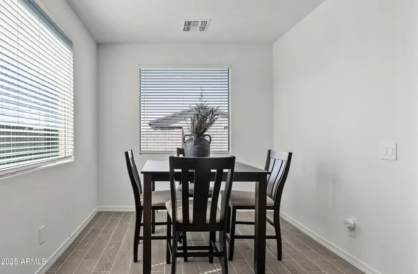 a view of a dining room with furniture and wooden floor