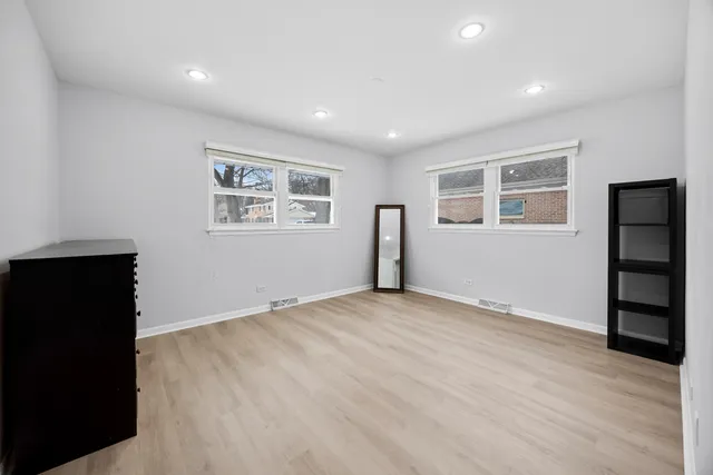 a bedroom with furniture and natural light