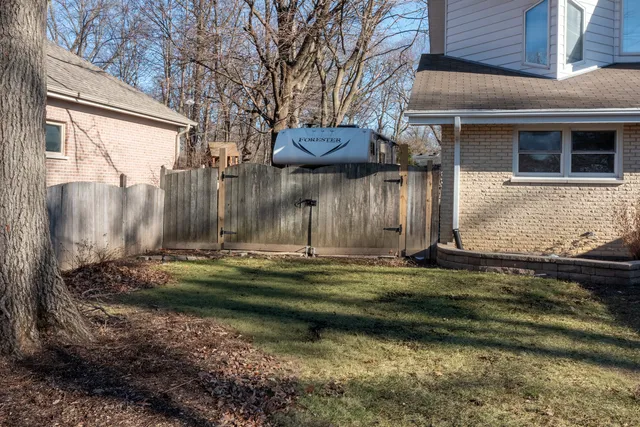 a front view of a house with garden and sitting area
