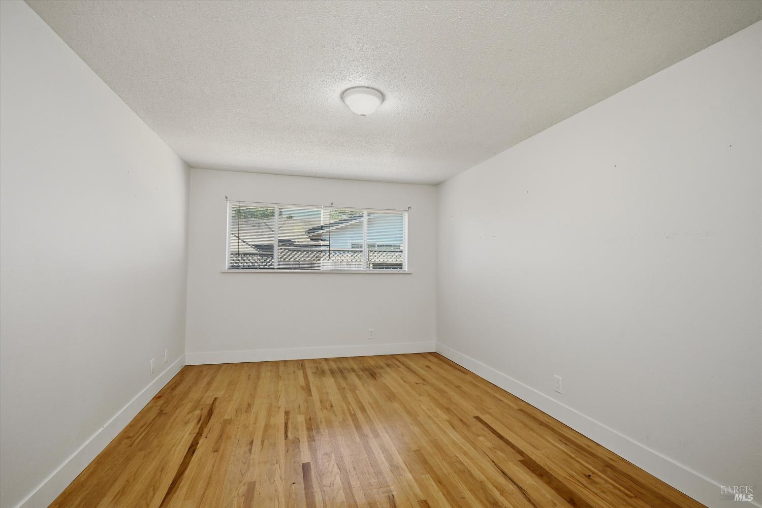 2537 Tamarisk Drive Santa Rosa, CA 95405 - Photo 16 of 25 a view of empty room with wooden floor