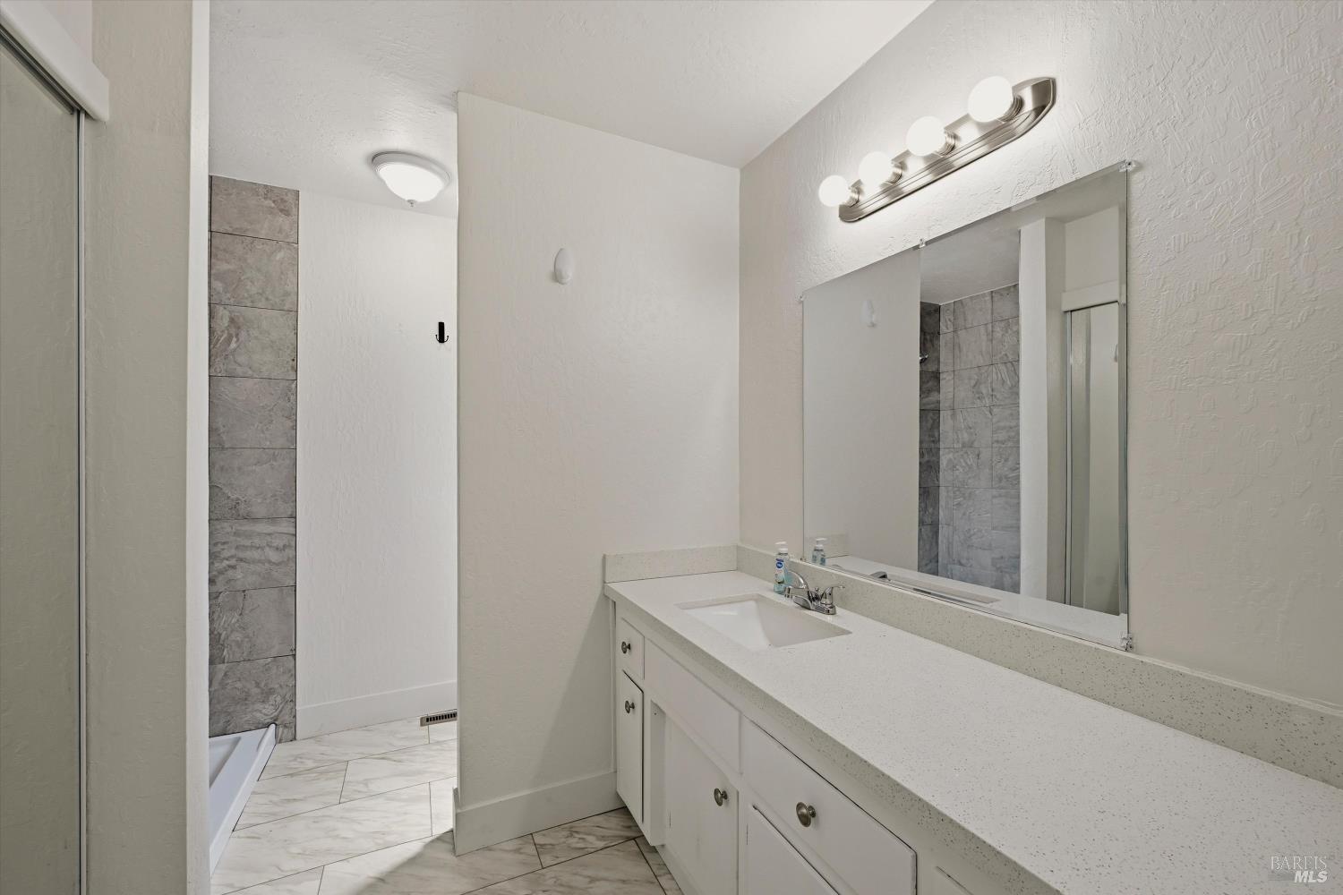 2537 Tamarisk Drive Santa Rosa, CA 95405 - Photo 18 of 25 a bathroom with a sink and a mirror