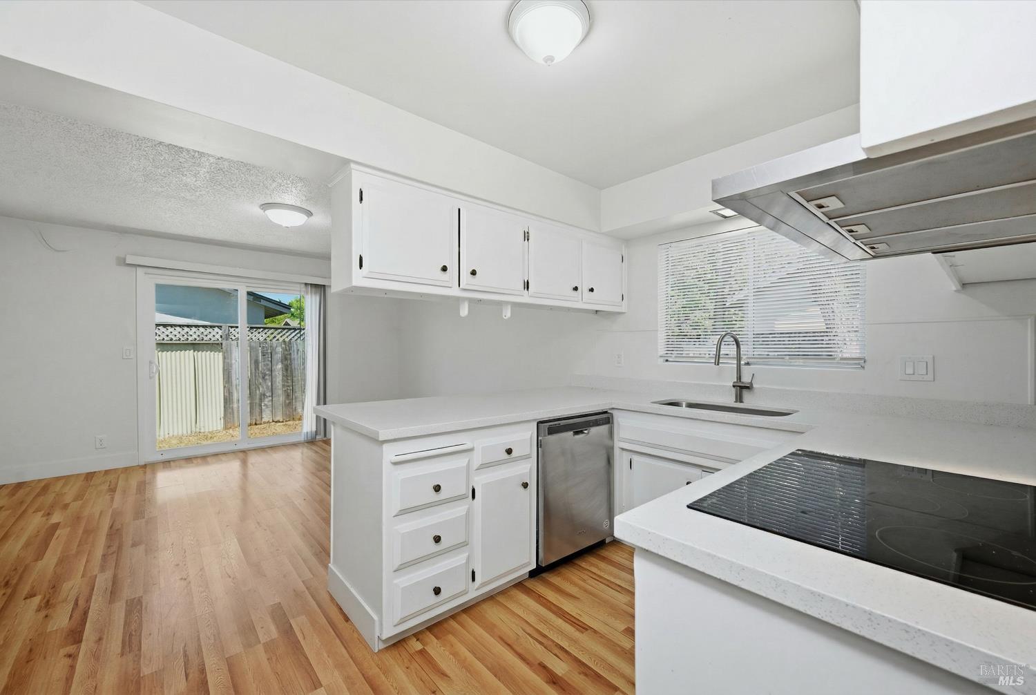 2537 Tamarisk Drive Santa Rosa, CA 95405 - Photo 25 of 25 a kitchen with granite countertop white cabinets and white appliances