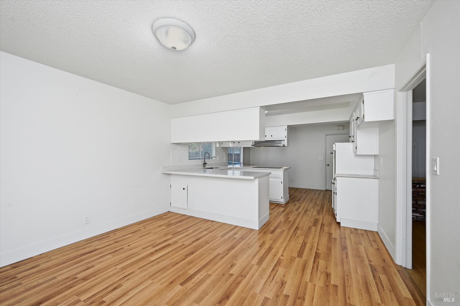 2537 Tamarisk Drive Santa Rosa, CA 95405 - Photo 9 of 25 a kitchen with a sink and wooden floor