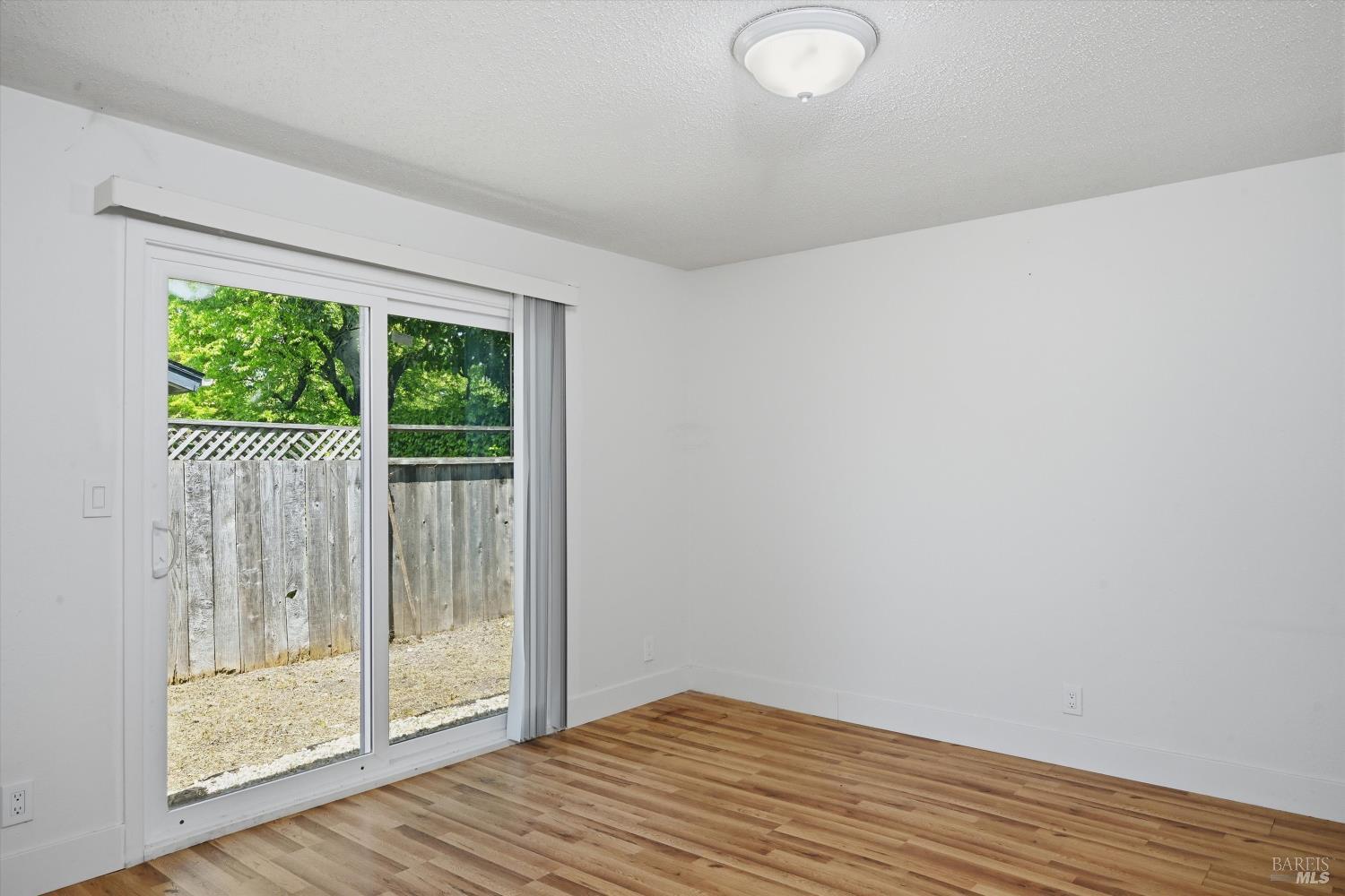 2537 Tamarisk Drive Santa Rosa, CA 95405 - Photo 10 of 25 a view of a room with wooden floor and sliding door