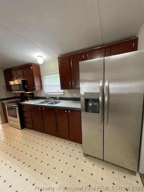 981 Black Road Cameron, NC 28326 - Photo 19 of 39 a kitchen with a sink a refrigerator and a stove