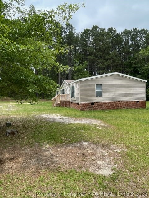 981 Black Road Cameron, NC 28326 - Photo 3 of 39 a view of a backyard with barn