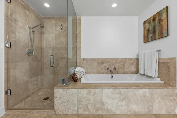 a bathroom with a bathtub and shower