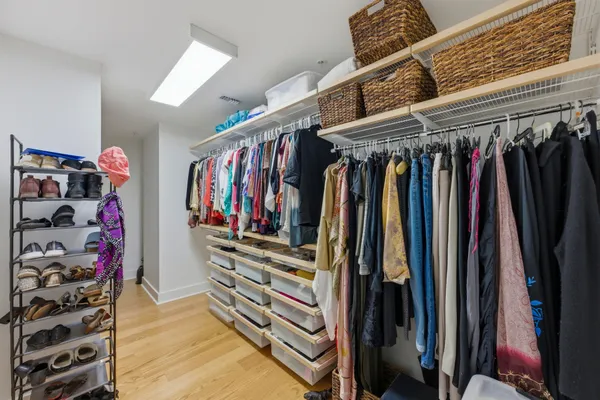 a view of walk in closet with clothes