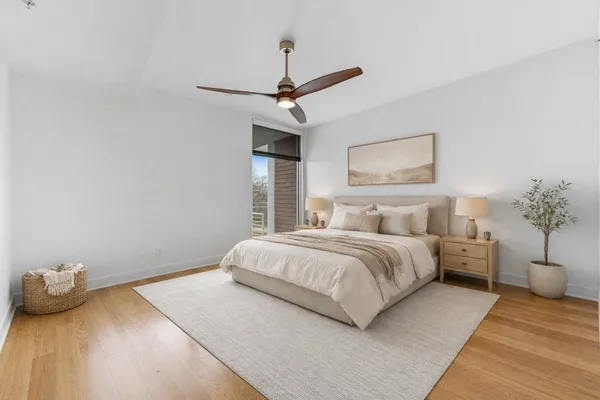 a bedroom with a bed and a chandelier