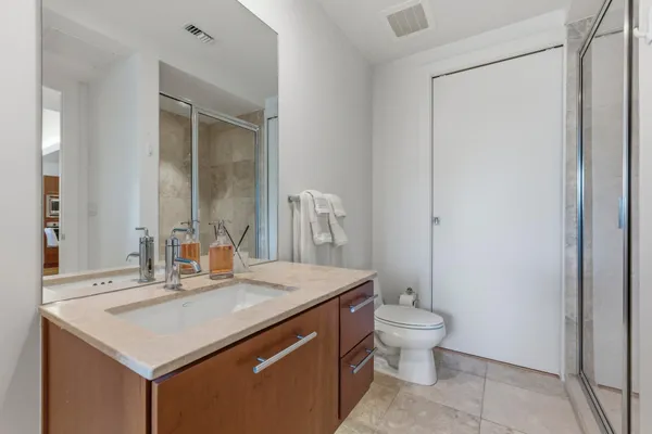 a bathroom with a sink toilet and mirror