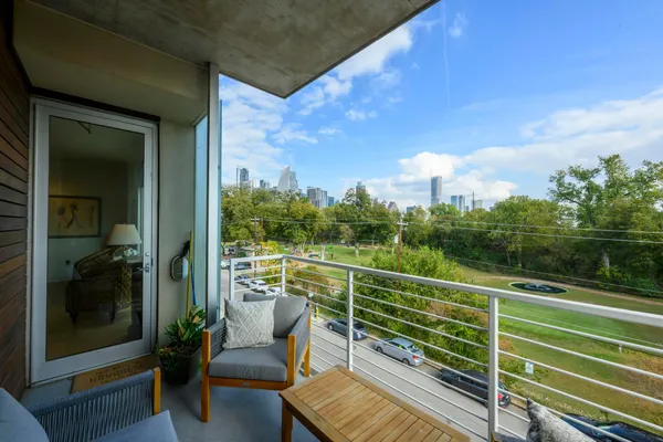 a view of a balcony with chair and wooden floor