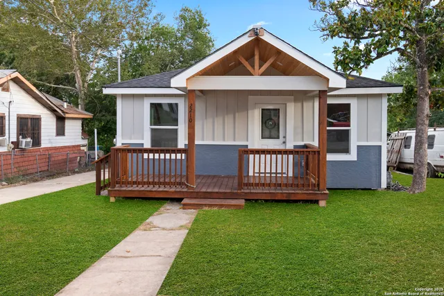 a view of a house with a yard and deck