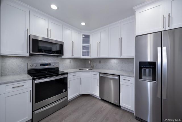1510 August Road, Unit 1510 North Babylon, NY 11703 - Photo 2 of 11 a kitchen with stainless steel appliances granite countertop a refrigerator stove a sink and microwave