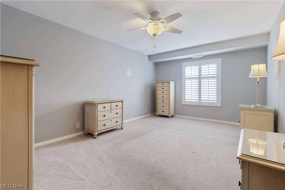 22555 Center Ridge Road, Unit 303 Rocky River, OH 44116 - Photo 18 of 33 Master bedroom featuring light carpet and ceiling fan