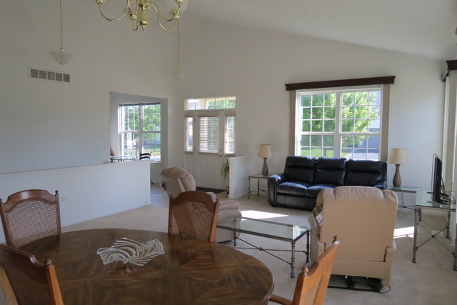 992 Oak Ridge Boulevard Elgin, IL 60120 - Photo 11 of 25 a living room with furniture a window and a chandelier