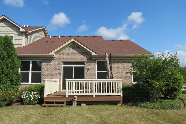 992 Oak Ridge Boulevard Elgin, IL 60120 - Photo 23 of 25 a view of a house with a yard and furniture