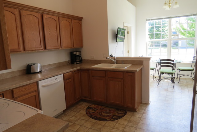 992 Oak Ridge Boulevard Elgin, IL 60120 - Photo 7 of 25 a kitchen with stainless steel appliances granite countertop a sink stove and cabinets