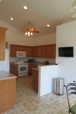992 Oak Ridge Boulevard Elgin, IL 60120 - Photo 10 of 25 a kitchen with stainless steel appliances kitchen island granite countertop a stove a sink and a microwave