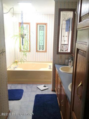 3113 Bear Road Bushkill, PA 18324 - Photo 13 of 38 a bathroom with a tub sink and mirror