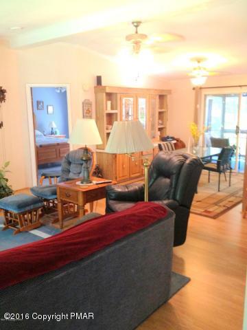 3113 Bear Road Bushkill, PA 18324 - Photo 16 of 38 a living room with furniture a flat screen tv and next to a window