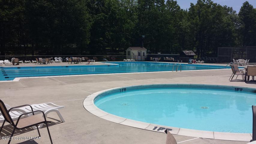 3113 Bear Road Bushkill, PA 18324 - Photo 17 of 38 a view of a swimming pool with a lawn chairs