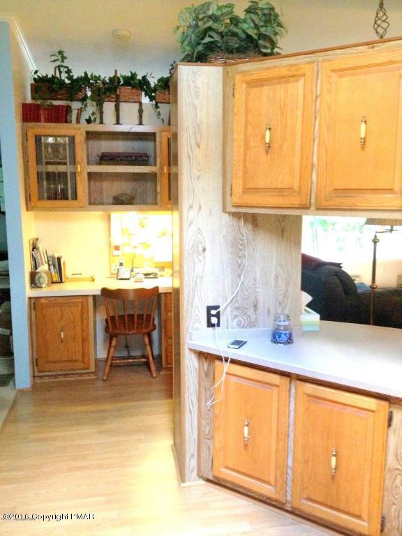 3113 Bear Road Bushkill, PA 18324 - Photo 21 of 38 a kitchen with stainless steel appliances kitchen island granite countertop a sink and cabinets
