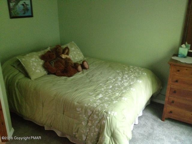 3113 Bear Road Bushkill, PA 18324 - Photo 24 of 38 a bed sitting in a bedroom next to a window