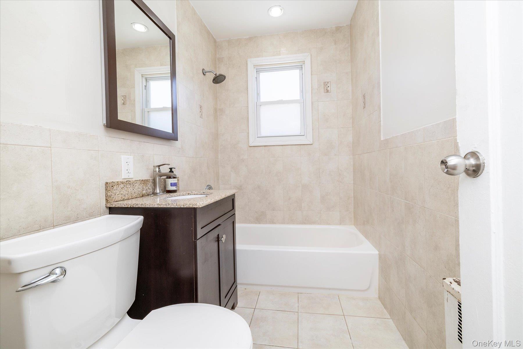 191 Raff Avenue Mineola, NY 11501 - Photo 19 of 25 a bathroom with a sink toilet and shower